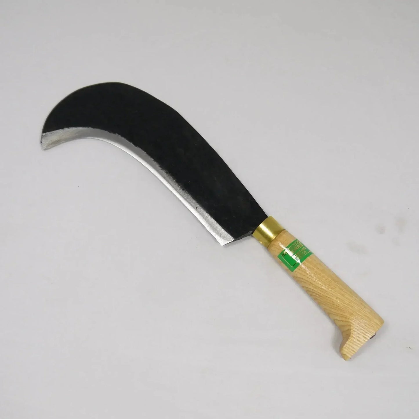 Sharp billhook tool with curved black blade and wooden handle on white background