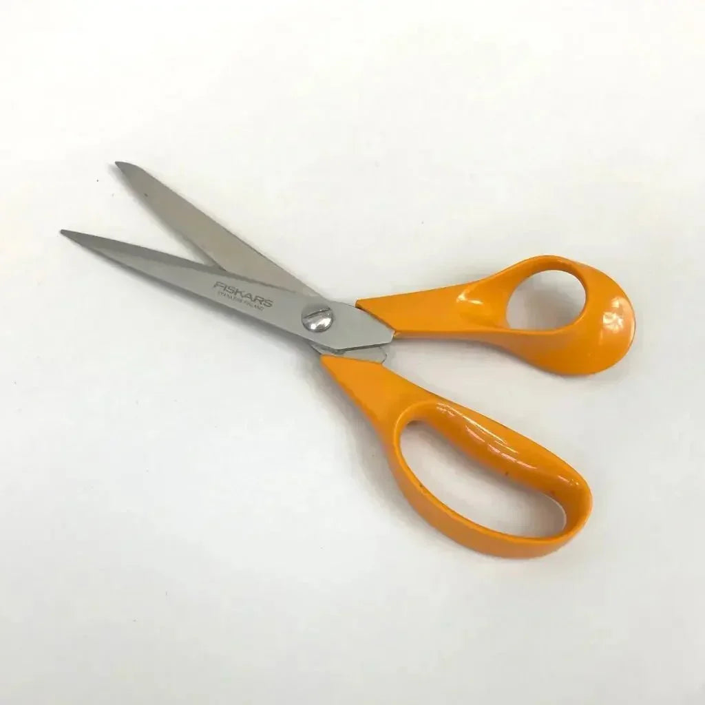 General purpose scissors with orange handles for sharpening service on white background