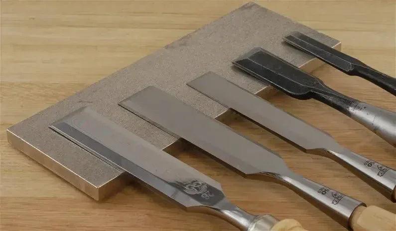 Sharpening chisels on a whetstone, professional blade sharpening service in Somerset
