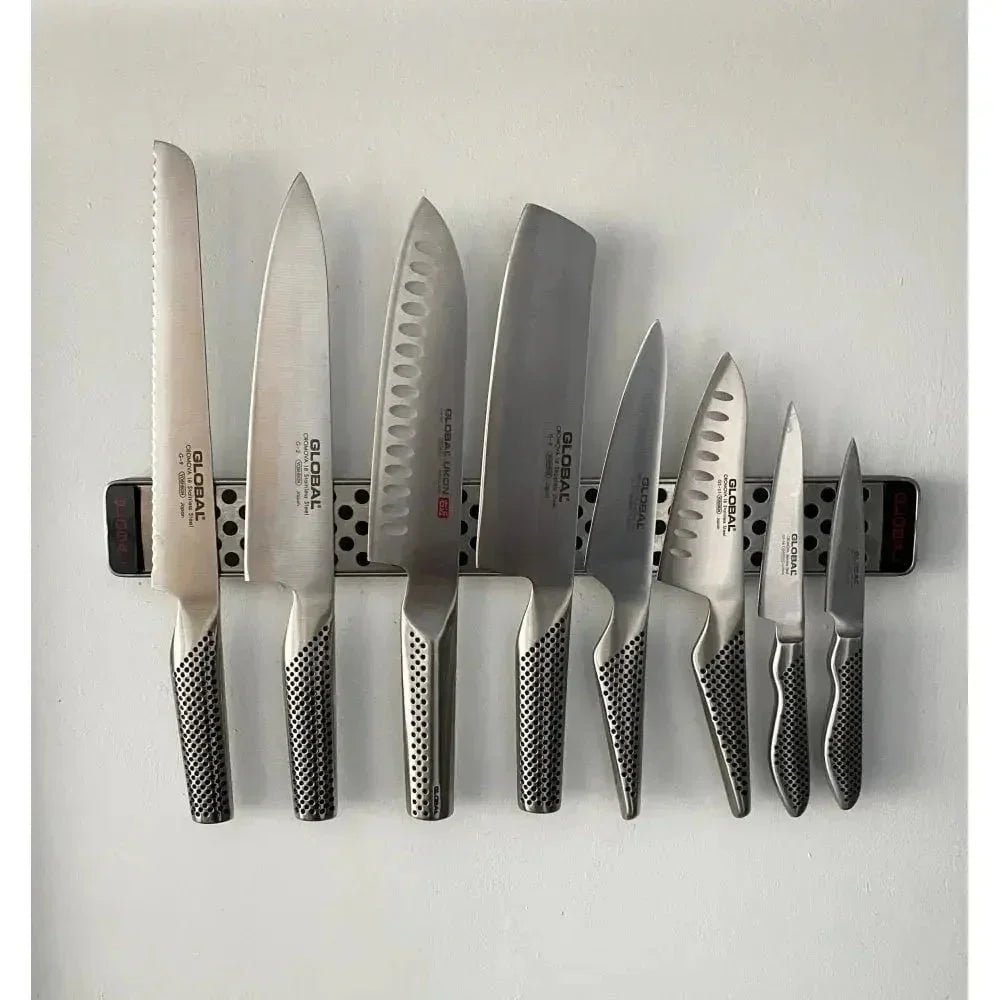 Global kitchen knives on magnetic strip, ready for professional sharpening services in Somerset