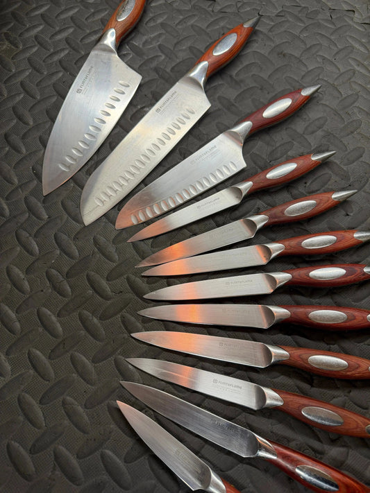 Set of Flint & Flame kitchen knives with wooden handles on textured surface
