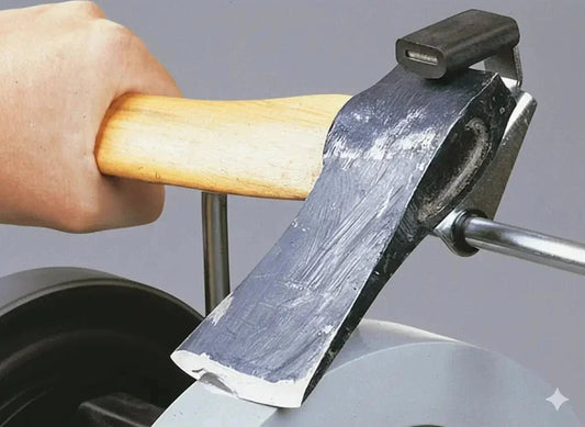 Sharpening an axe blade with a professional sharpening tool for precise edge restoration.