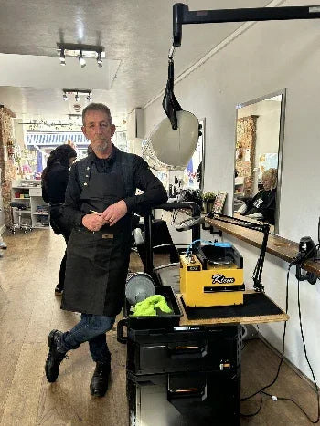 Man in a workshop setting with tools and equipment