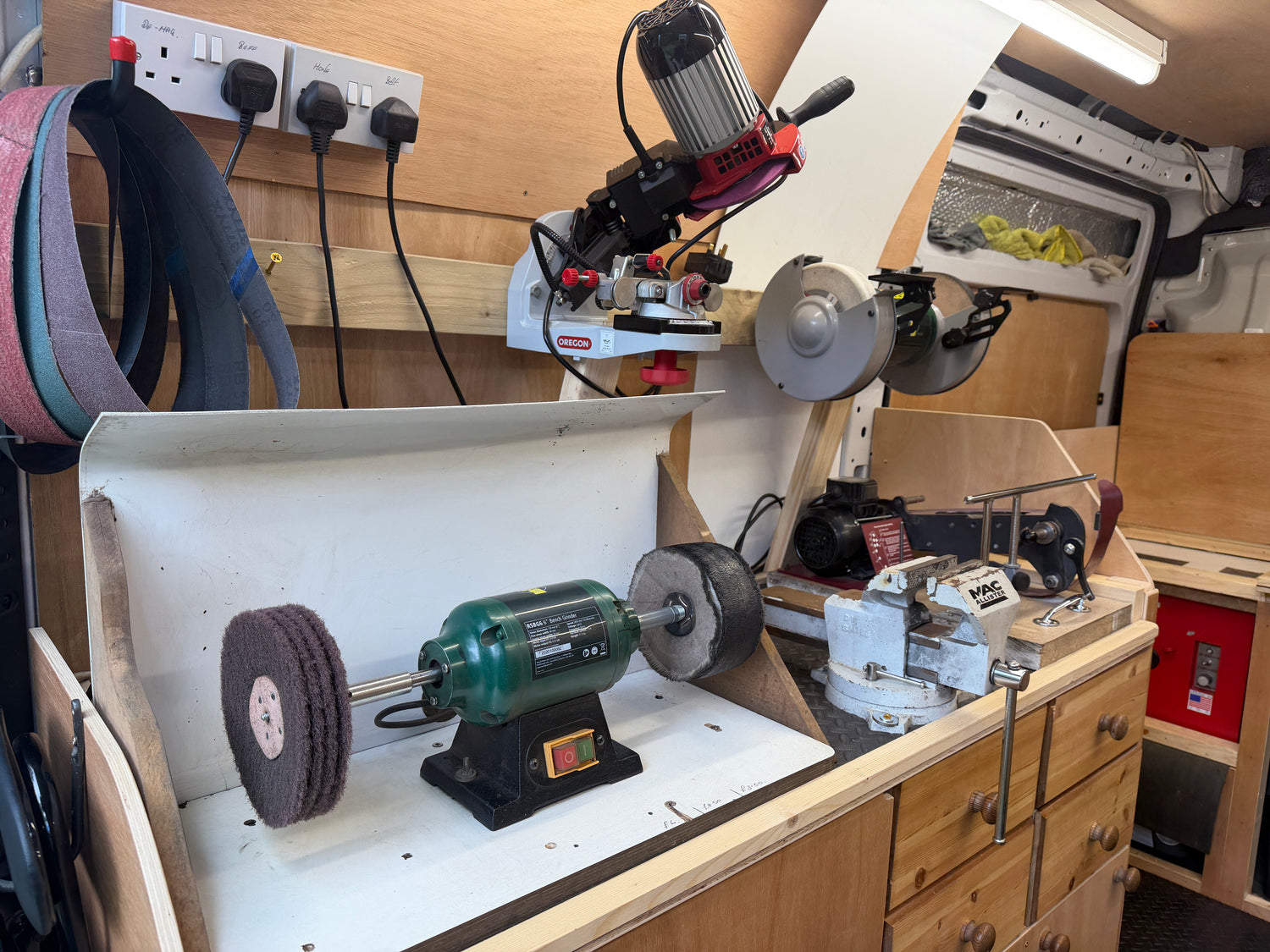 Workbench with various tools and equipment in a workshop setting