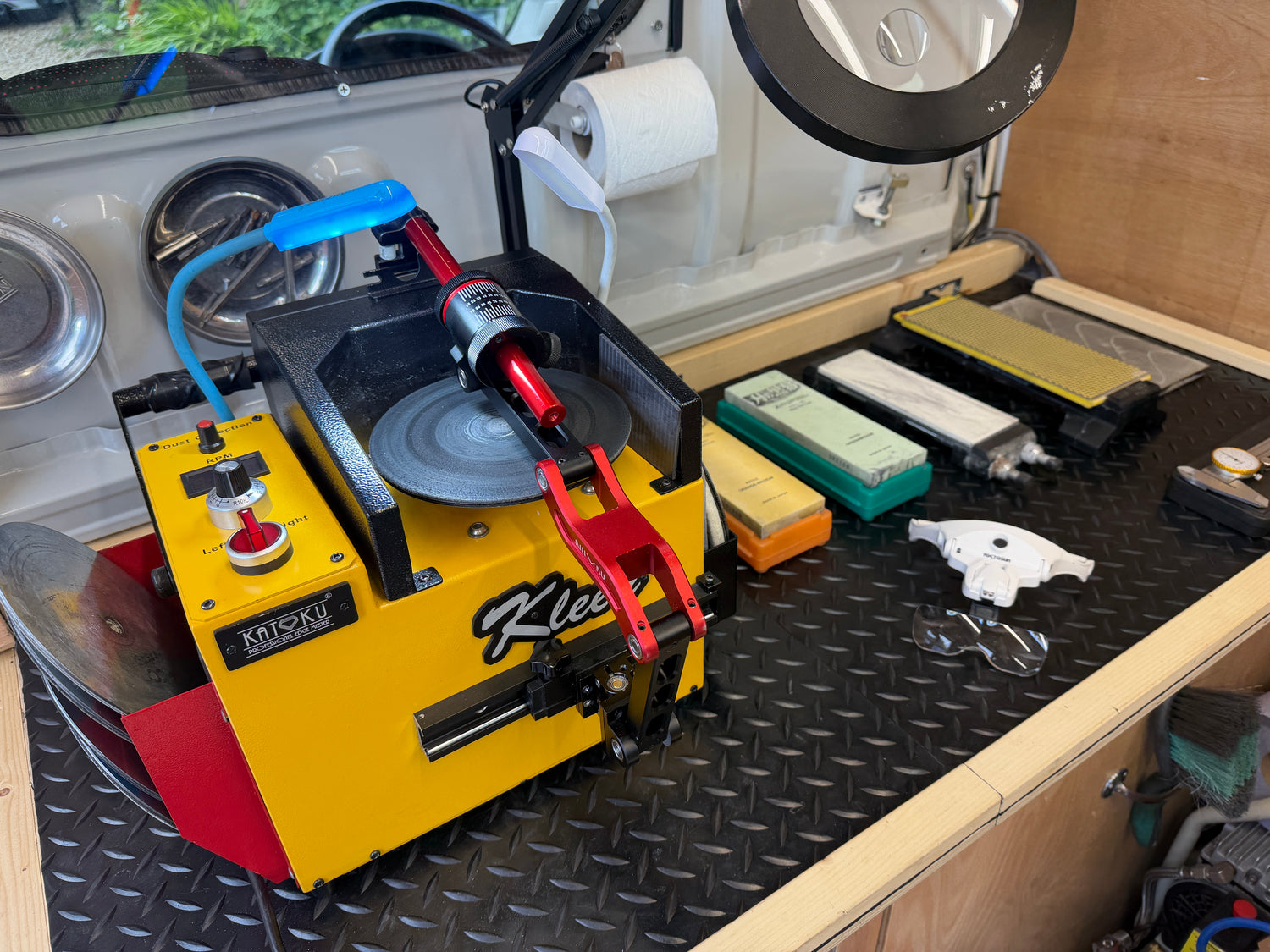  scissor sharpener on a workbench with various tools and equipment.