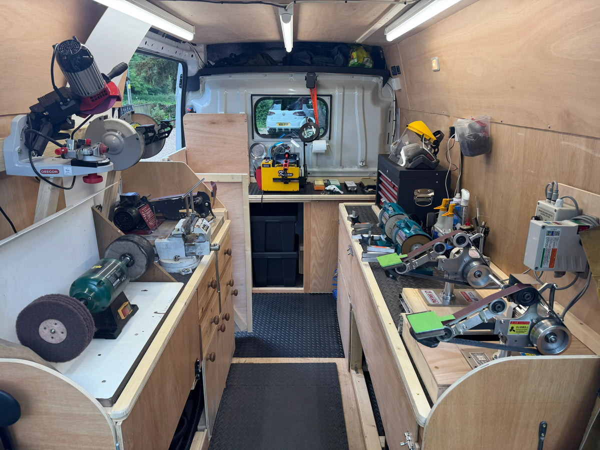 Workshop setup inside a van with tools and equipment.