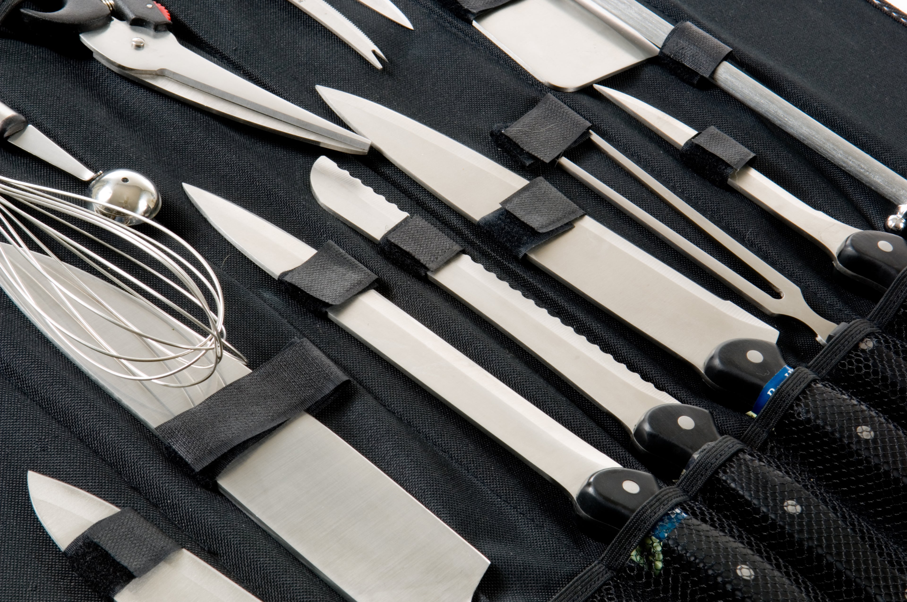 Set of knives and kitchen tools in a black case