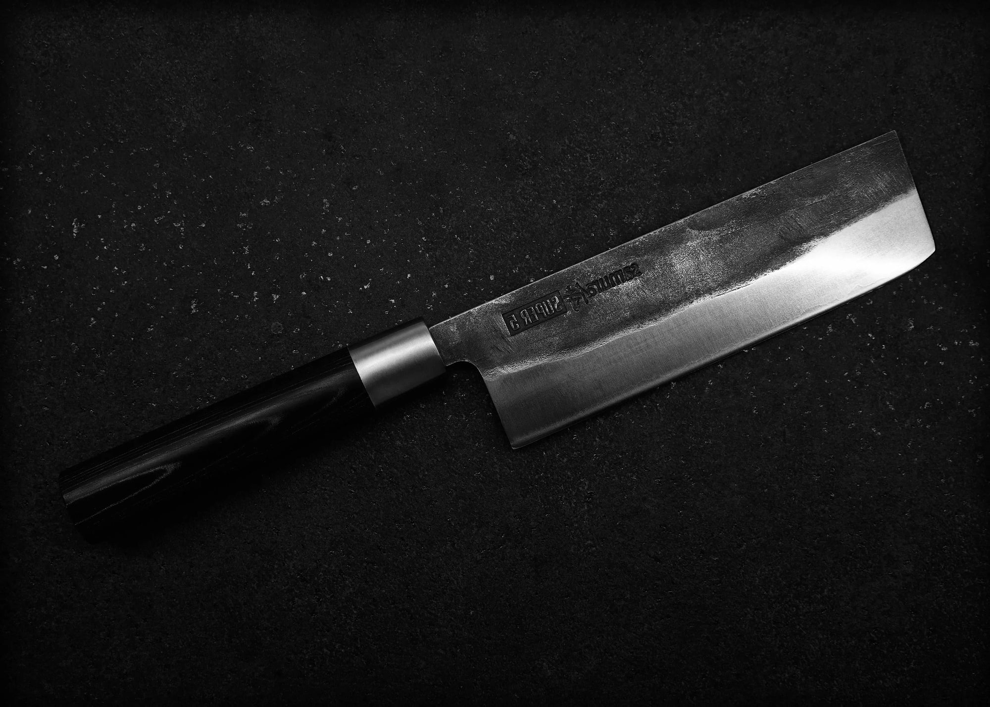 Knife with a black handle on a dark background